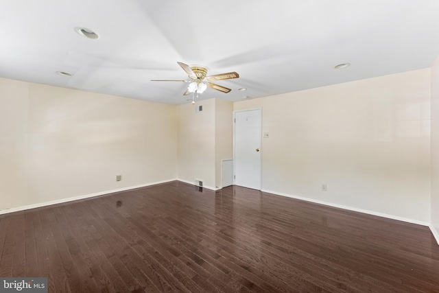 spare room with dark hardwood / wood-style floors and ceiling fan