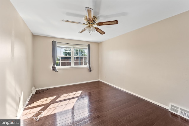 unfurnished room featuring ceiling fan and dark wood-type flooring