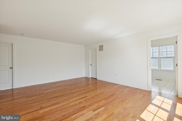 spare room featuring light wood-type flooring