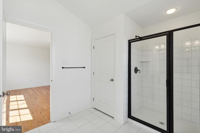 bathroom featuring walk in shower and hardwood / wood-style floors