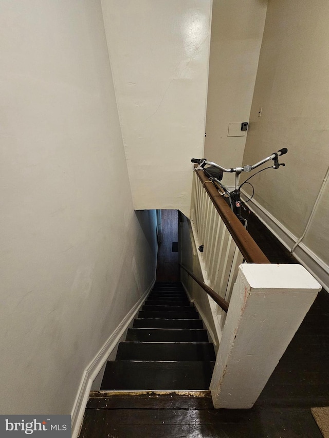 stairway featuring hardwood / wood-style flooring