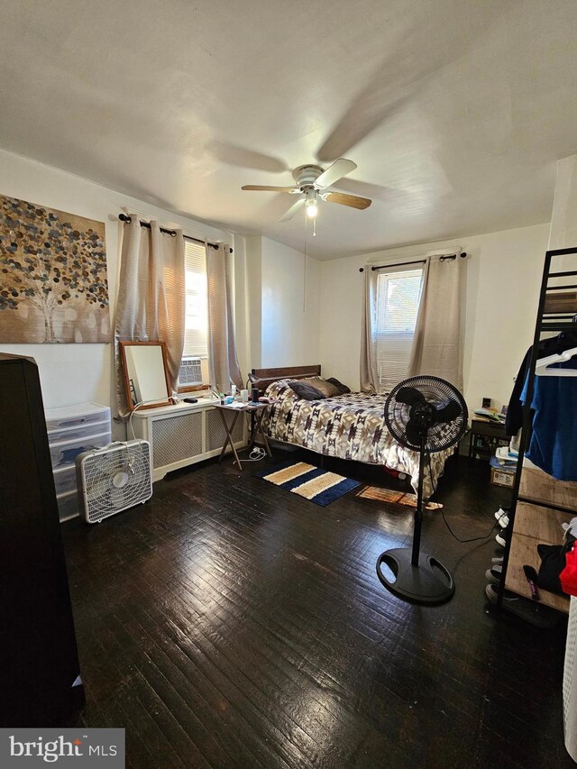 bedroom featuring ceiling fan and dark hardwood / wood-style flooring