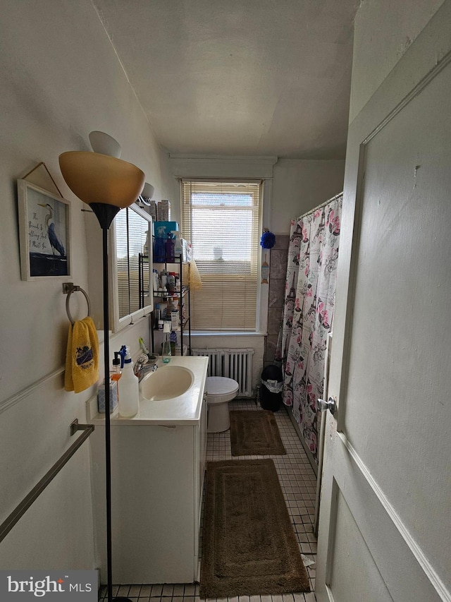 bathroom with curtained shower, vanity, radiator heating unit, toilet, and tile patterned floors