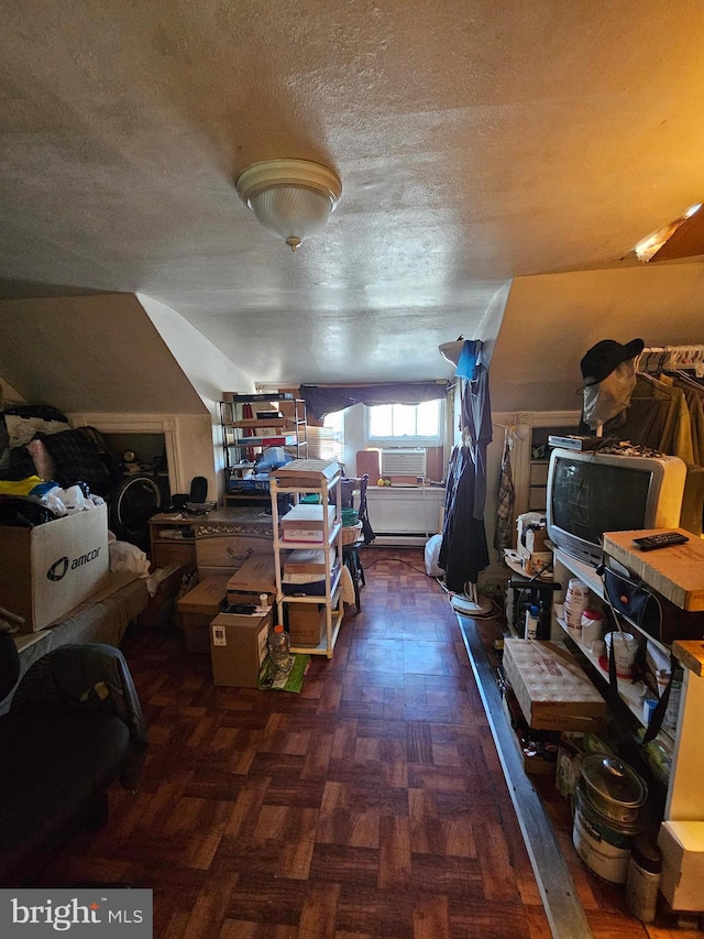 interior space with cooling unit, a textured ceiling, lofted ceiling, and dark parquet floors