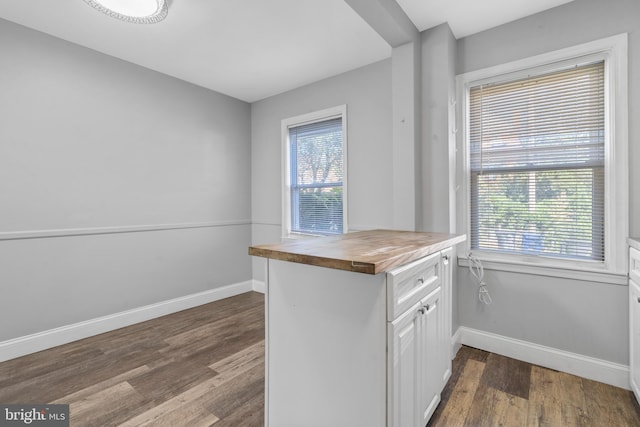 kitchen with white cabinetry, wooden counters, and dark hardwood / wood-style flooring