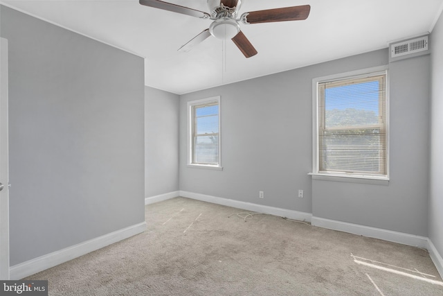 carpeted spare room featuring ceiling fan