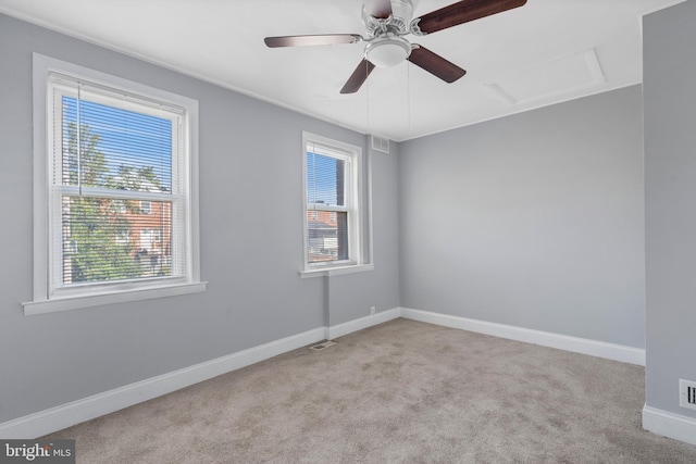 carpeted empty room featuring ceiling fan