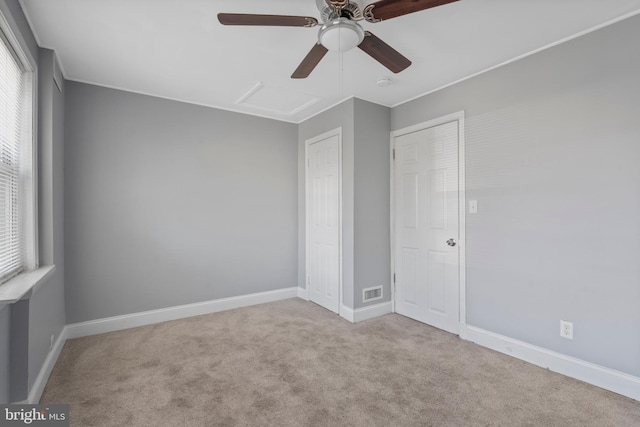 carpeted spare room with ceiling fan