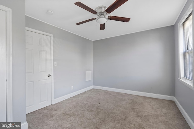 empty room with light colored carpet and ceiling fan