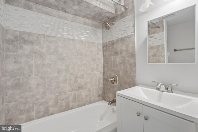 bathroom with vanity and tiled shower / bath