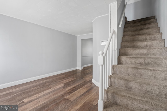 stairway with hardwood / wood-style floors