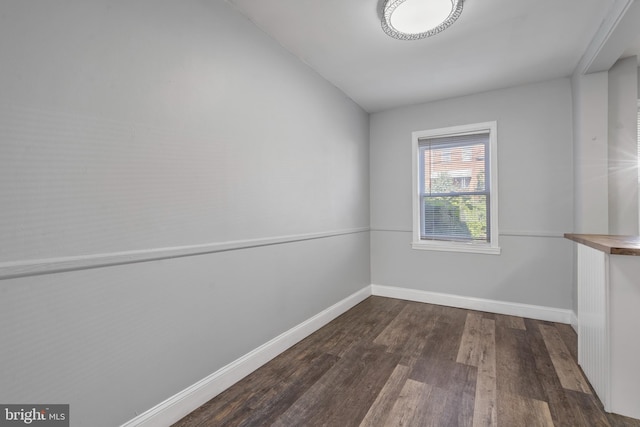 spare room with dark hardwood / wood-style flooring