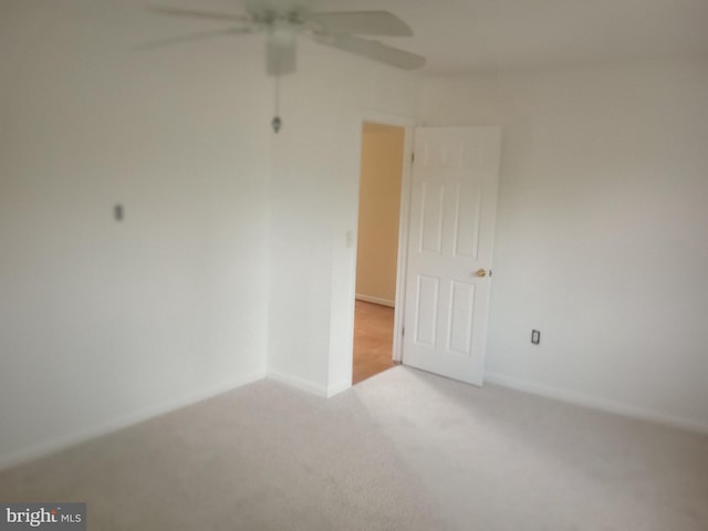 empty room featuring light carpet and ceiling fan