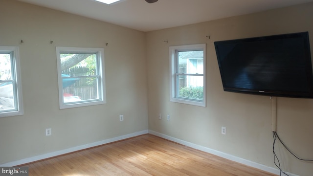 unfurnished living room with a healthy amount of sunlight and light hardwood / wood-style floors