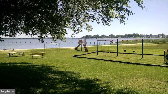 view of community with a water view and a playground