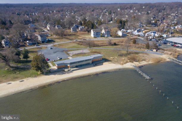 drone / aerial view featuring a beach view and a water view