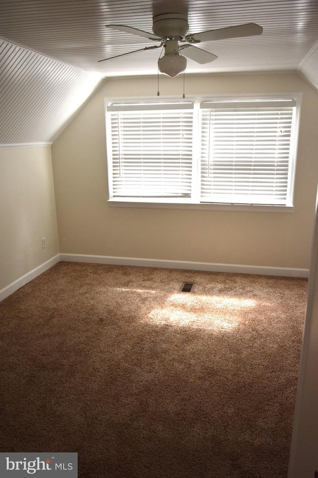 bonus room with lofted ceiling, ceiling fan, plenty of natural light, and carpet