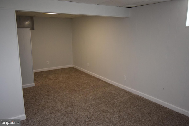 basement featuring dark colored carpet