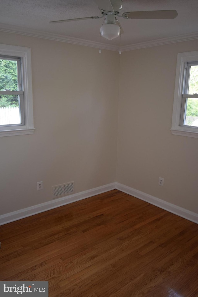 spare room with crown molding, ceiling fan, and wood-type flooring