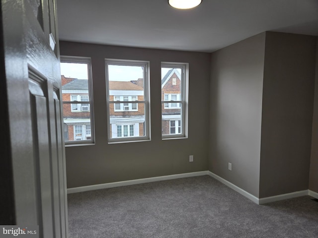 carpeted spare room featuring a wealth of natural light