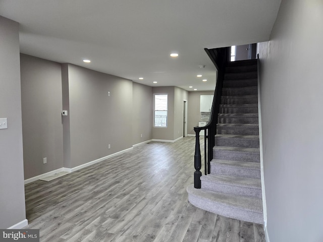 staircase featuring wood-type flooring