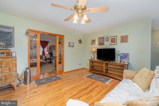 living room featuring ceiling fan and light wood-type flooring