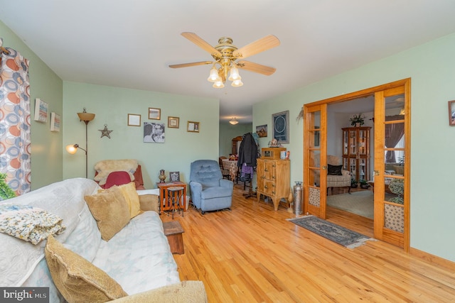 living room with ceiling fan and wood-type flooring