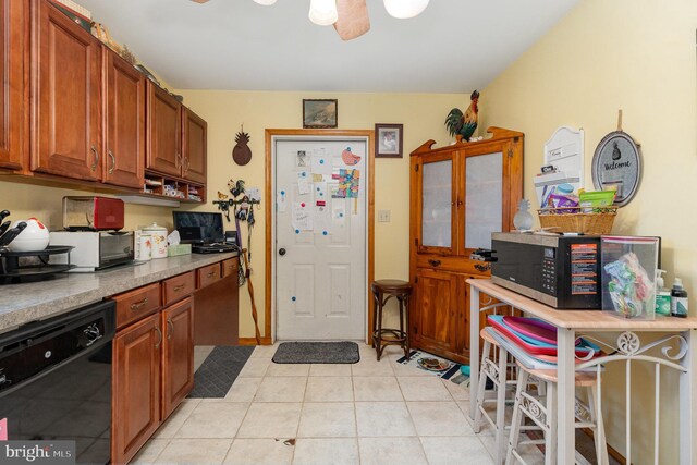 kitchen with black appliances, ceiling fan, sink, and light tile patterned flooring