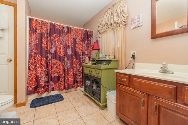 bathroom with tile patterned flooring, vanity, and toilet