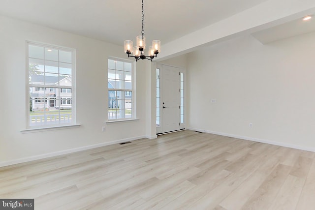 entryway featuring an inviting chandelier and light wood-type flooring