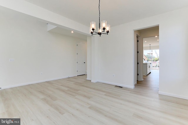 interior space with light hardwood / wood-style floors and a chandelier