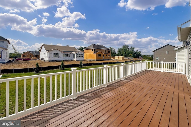 wooden terrace featuring a lawn