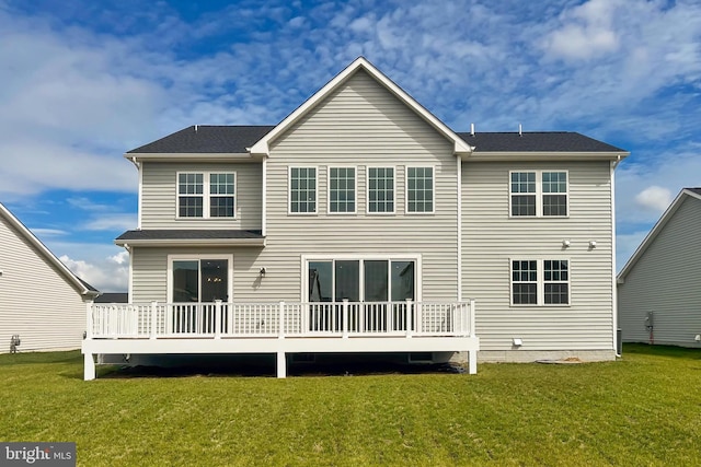 back of house featuring a wooden deck and a lawn