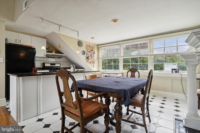 dining space featuring visible vents, track lighting, and light floors