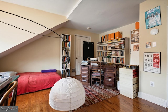 bedroom with baseboards and wood finished floors