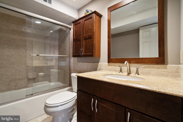 full bathroom featuring visible vents, toilet, shower / bath combination with glass door, and vanity