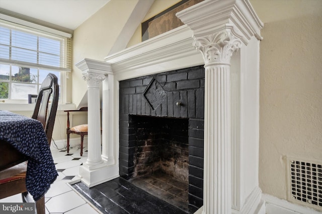 room details featuring decorative columns, a fireplace, and visible vents