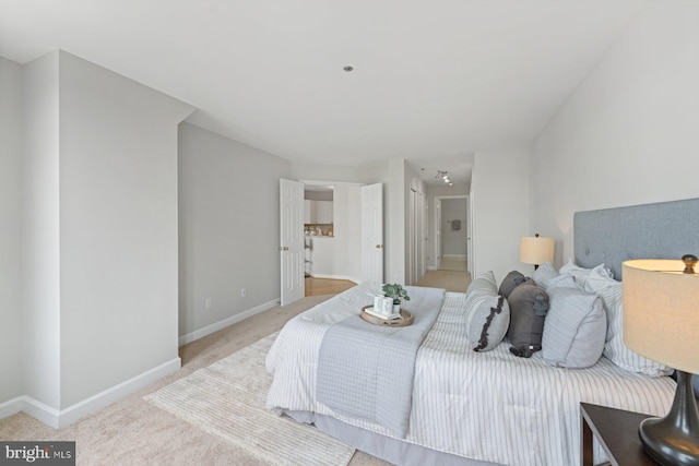 bedroom featuring light colored carpet