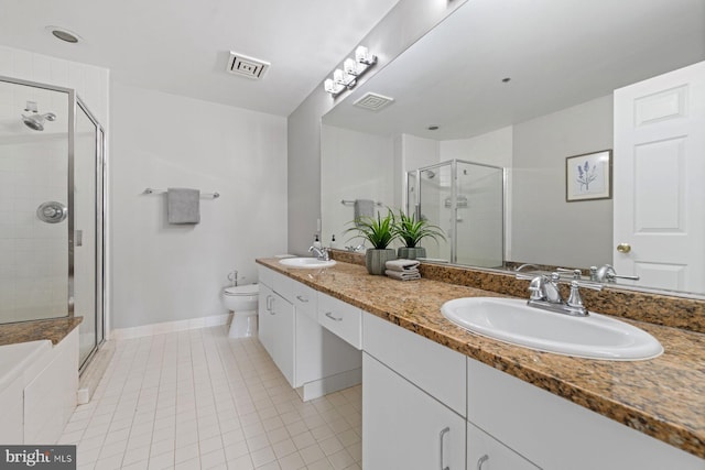 bathroom featuring a shower with door, vanity, toilet, and tile patterned floors