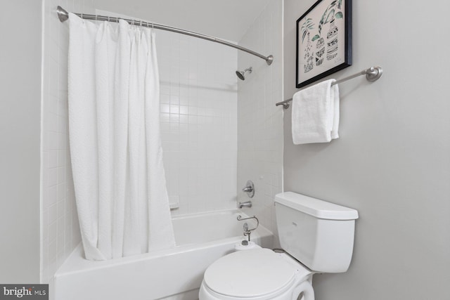 bathroom featuring toilet and shower / bath combination with curtain