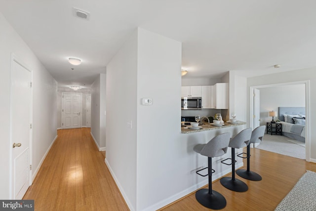 hall with light wood-type flooring