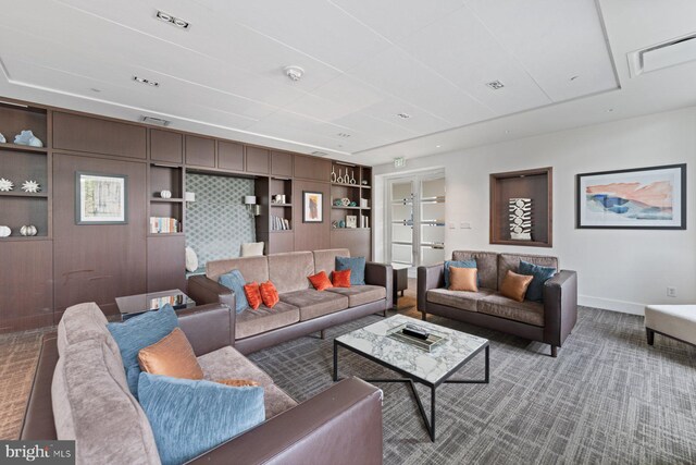 living room with built in shelves and carpet floors