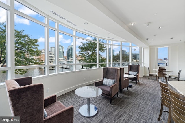 sunroom / solarium with a water view