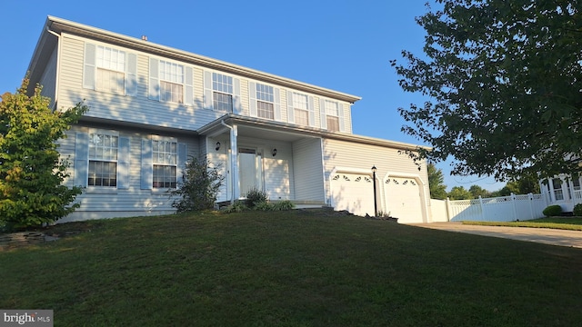 view of front of property with a garage and a front yard