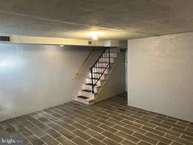 basement featuring dark hardwood / wood-style floors