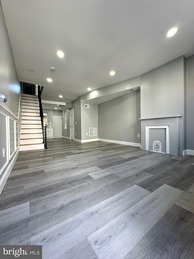 unfurnished living room with hardwood / wood-style floors and a fireplace