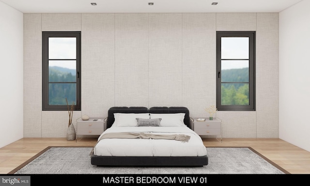 bedroom featuring hardwood / wood-style floors and multiple windows