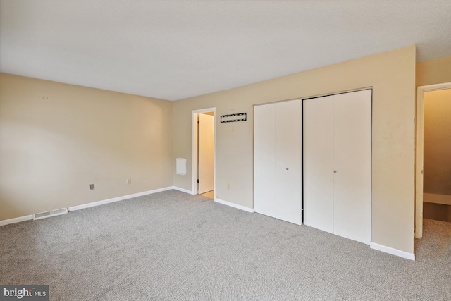 unfurnished bedroom featuring light carpet