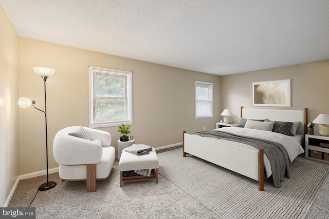 carpeted bedroom featuring a textured ceiling