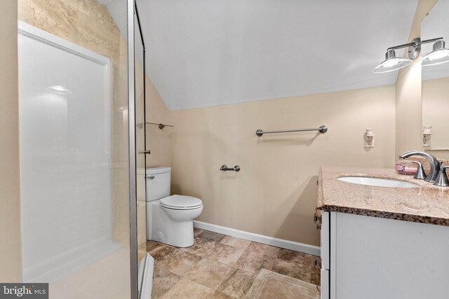 bathroom featuring lofted ceiling, vanity, toilet, and an enclosed shower